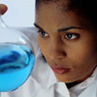 women scientist looking at a liquid